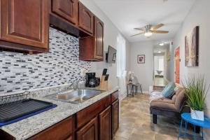 a kitchen with a sink and a living room at Modern 2 Bdrm 10 Mins Metro To City Center in Philadelphia