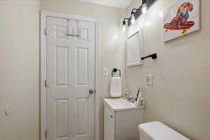 a white bathroom with a toilet and a sink at Modern 2 Bdrm 10 Mins Metro To City Center in Philadelphia