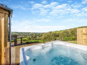 a hot tub on the side of a house at Westpitt Farm - The Hay Loft in Tiverton