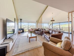 a large living room with couches and a television at Westpitt Farm - The Hay Loft in Tiverton