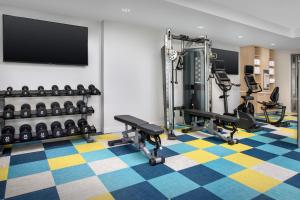 a gym with exercise equipment and a flat screen tv at TownePlace Suites by Marriott Cincinnati Mason in Mason