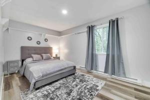 a bedroom with a bed and a large window at Cozy, Spacious House *New*InTheCommunity+Fire Pit in Tobyhanna +22 photos