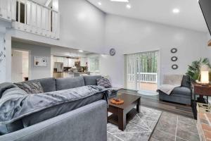 a living room with a couch and a table at Cozy, Spacious House *New*InTheCommunity+Fire Pit in Tobyhanna