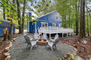 a group of chairs around a fire pit in front of a blue house at Cozy, Spacious House *New*InTheCommunity+Fire Pit in Tobyhanna