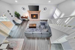 a living room with a couch and a fireplace at Cozy, Spacious House *New*InTheCommunity+Fire Pit in Tobyhanna