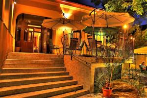 a set of stairs with chairs and umbrellas on a house at Hotel Rokoko in Košice