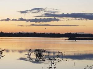 a large body of water with a sunset in the background at Hidden Paradise - Cottage in Nassau