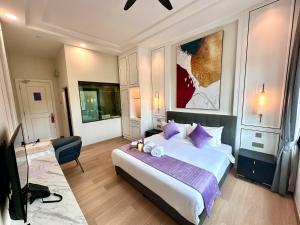 a bedroom with a large bed with purple pillows at Cameron Lavender Mansion by PLAY in Brinchang