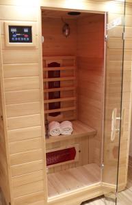 a sauna with two towels and a glass door at Apartment Rose Sasbachwalden in Sasbachwalden