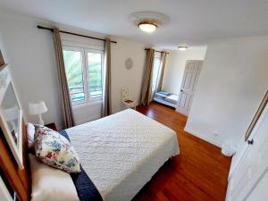 a bedroom with a bed and a window at La Finca de Ananás - House in Ponta Delgada +19 photos