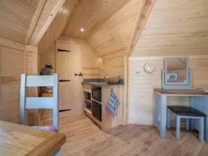 a kitchen in a wooden cabin with a sink at Dol Y Mynydd the Mountain Meadow-qu7521 in Llangerniew