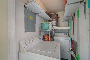 a small kitchen with a sink and a washing machine at West Bay Cove 218 condo in Holmes Beach