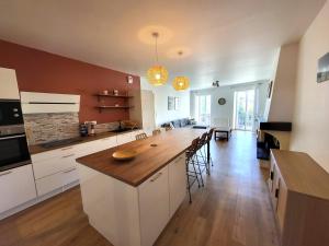a large kitchen with a long island in a room at Appartement Lafayette N°3 in Bagnères-de-Bigorre