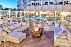 a hotel patio with a fire pit and a pool at Amazing view from your balcony Walk to the beach 2420 in Honolulu