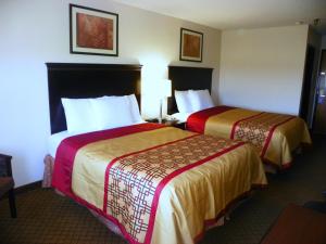 a hotel room with two beds in a room at Royalton Inn & Suites Upper Sandusky in Upper Sandusky +21 photos