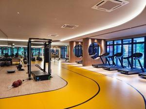 a gym with treadmills and exercise equipment in a building at 5 mins to IKEA Mytown M Vertica Hanan Residence in Kuala Lumpur
