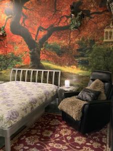 a bedroom with a tree mural on the wall at Private small suite with private bathroom and parking on property in Vernon
