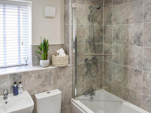 a bathroom with a shower and a toilet and a sink at The Gables in Helmsley
