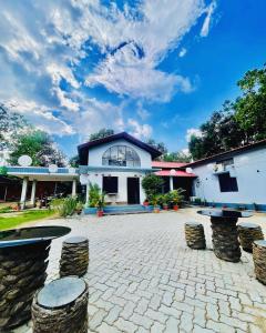 a building with stools in front of a courtyard at Urban Villa in Guwahati