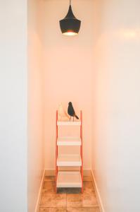 a bird sitting on a shelf in a room at Jeju Love Stay Purple in Jeju