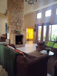 a living room with a couch and a fireplace at Campestre House in Alto Boquete