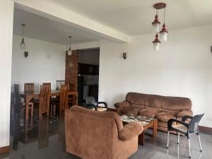 a living room with a couch and a table at Arcadia House Hanthana in Kandy