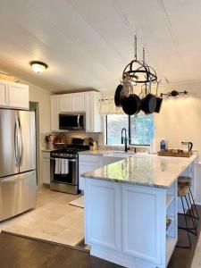 a kitchen with white cabinets and a large counter top at B-B Ranch Cottage~Heart of Gold Country~*HOT TUB* in Pilot Hill
