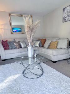 a living room with a glass table in front of a couch at 2 story Casual Cute Condo 6 miles from Disneyland & 8 miles Knotts 2bd 2bth Sleeps 8 plus in Cypress