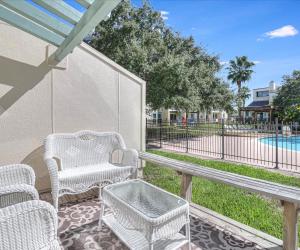 a patio with a table and chairs and a pool at Tranquil Bay RRYC50 in Rockport