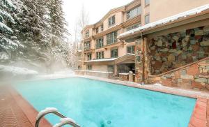 a large blue swimming pool in front of a building at The Galatyn Lodge in Vail