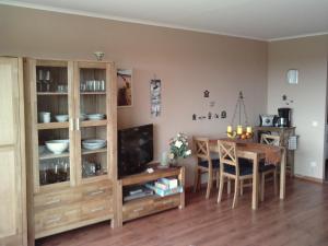 a kitchen and dining room with a table and a television at Ferienappartement E612 für 2 Personen an der Ostsee in Brasilien