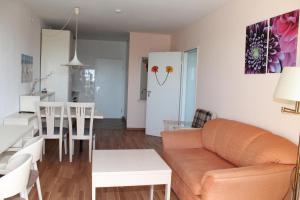 a living room and kitchen with a couch and a table at Ferienwohnung E623 für 2-4 Personen an der Ostsee in Brasilien