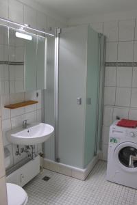 a bathroom with a washing machine and a sink at Ferienwohnung F109 in Brasilien