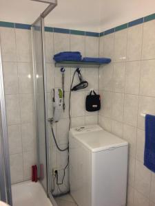 a bathroom with a shower and a toilet and a phone at Ferienappartement K1102 für 2-4 Personen mit Weitblick in Brasilien