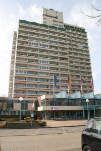 a large building with flags in front of it at Ferienappartement K1213 für 2-3 Personen mit Ostseeblick in Brasilien