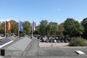 a parking lot with three flags and a skate park at Ostsee-Ferienapartement K217 für 2-4 Personen in Brasilien