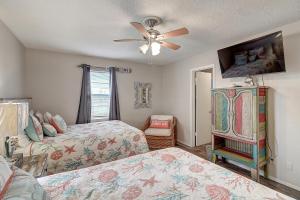 Un dormitorio con dos camas y un ventilador de techo. en Mermaid's Landing, en Rockport