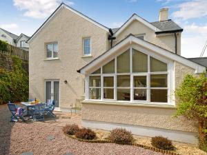 a house with a large window on the side of it at Havens Rest in Walton West