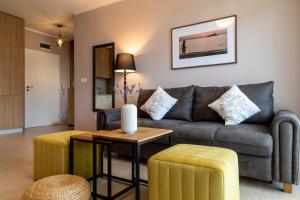 a living room with a couch and a table at Smokinia Sunrise - Kavatsi Beach, Sozopol in Sozopol +57 photos