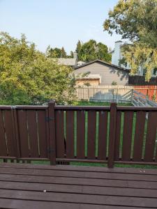 a wooden fence in front of a house at Bi-Level Suite in Saskatoon in Saskatoon