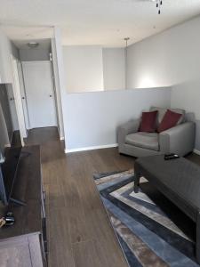 a living room with a couch and a table at Bi-Level Suite in Saskatoon in Saskatoon
