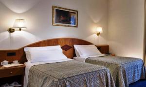 Säng eller sängar i ett rum på Hotel Lo Zodiaco
