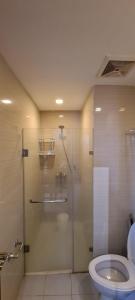 a bathroom with a shower and a toilet at F&M Relaxing Hotel in Manila