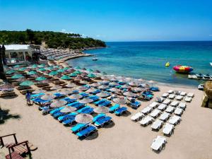 a bunch of chairs and umbrellas on a beach at CİTY POİNT BEACH&SPA HOTEL in Didim