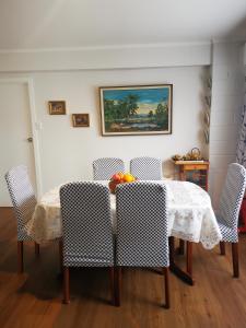 a dining room table with chairs and fruit on it at Nice house on Wesley Auckland in Auckland