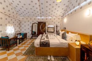 a bedroom with a large bed in a room at Golden Star Desert Camp in Jaisalmer