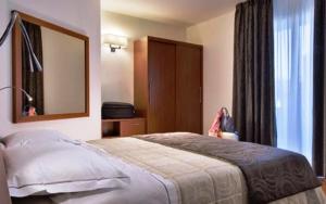 Säng eller sängar i ett rum på Hotel Lo Zodiaco