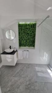 a bathroom with a sink and a green wall at Hagenauer House in Vienna