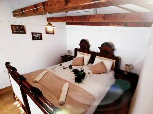 a bedroom with a large bed with a wooden headboard at Guest house Nostalgia in Gračišče