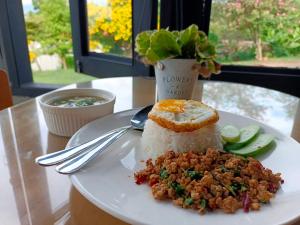 a plate of food with rice on a table at The Sunnery Ville in Lom Kao